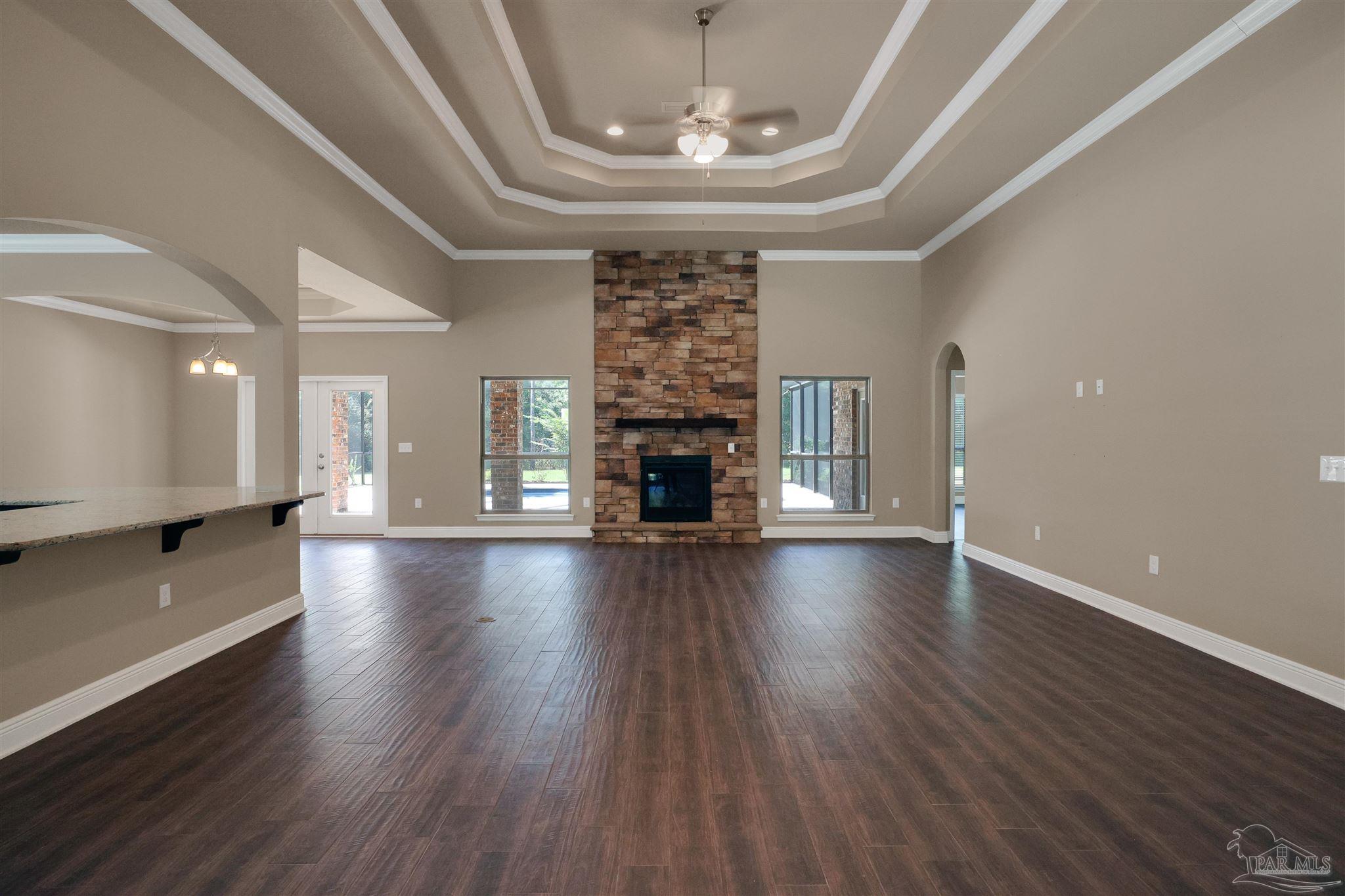 5847 Mossy Creek Lane Pace, FL 32571 - Photo 3 of 50 a view of a livingroom with wooden floor and a fireplace