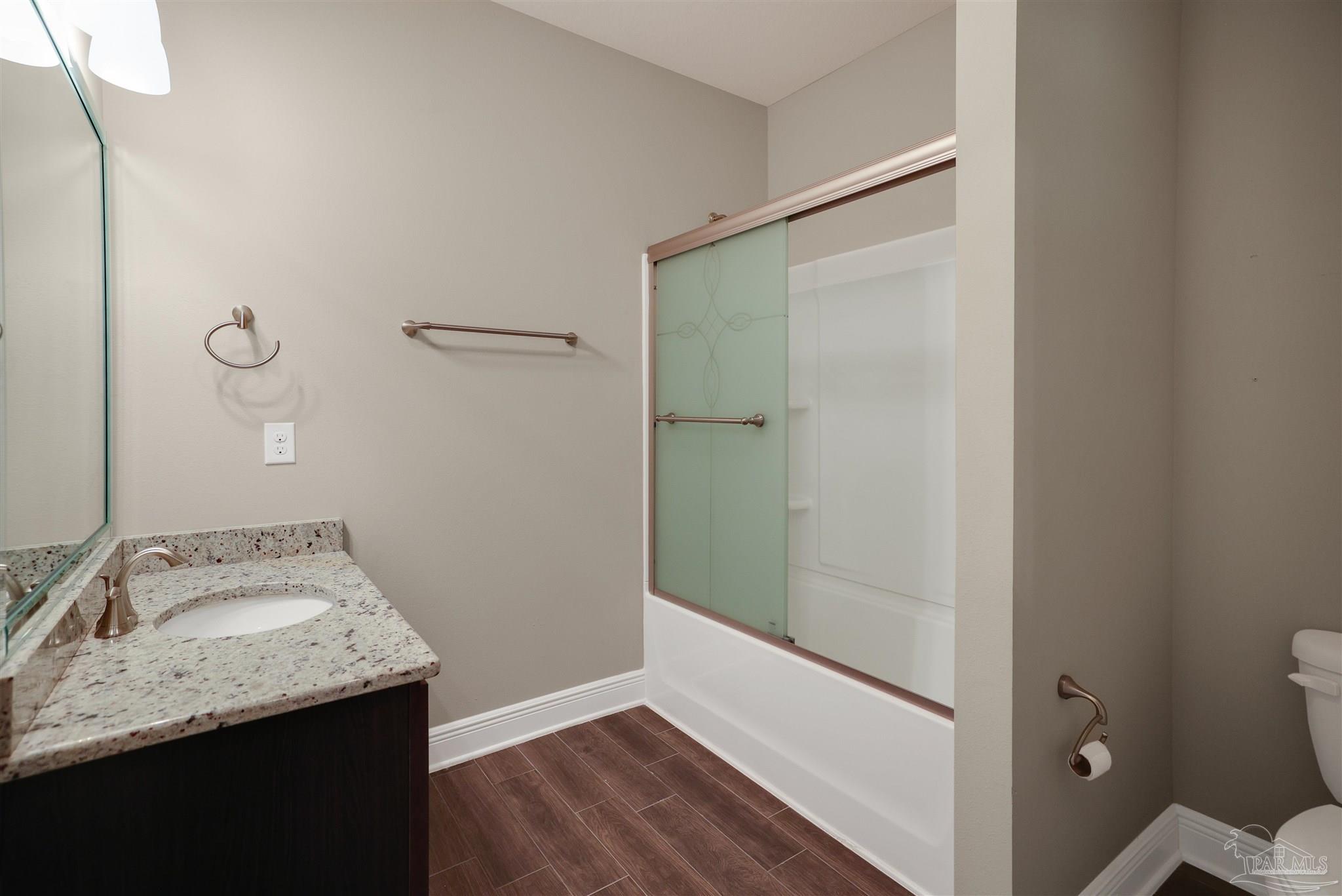5847 Mossy Creek Lane Pace, FL 32571 - Photo 31 of 50 a bathroom with a granite countertop sink a mirror and shower