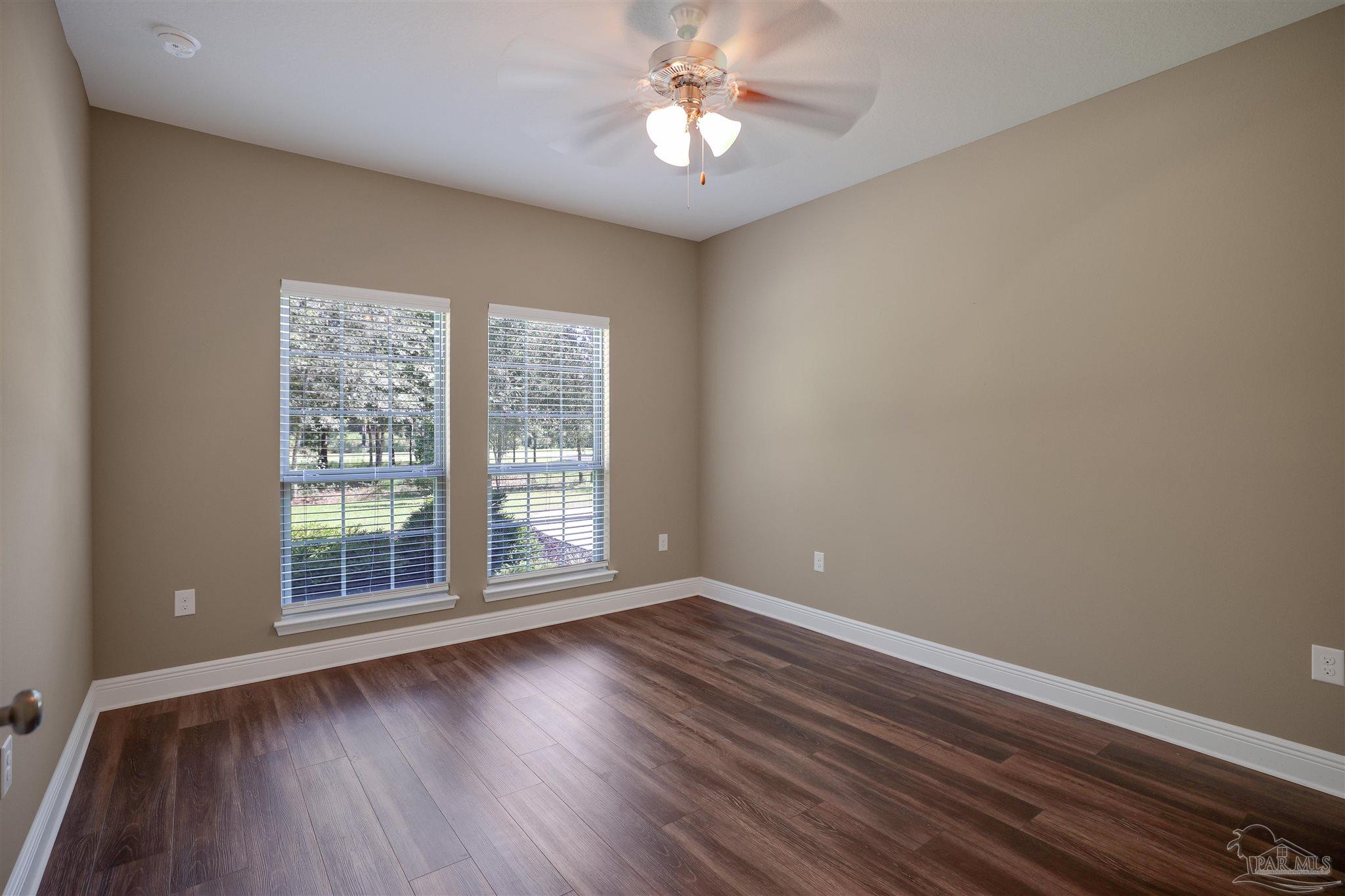 5847 Mossy Creek Lane Pace, FL 32571 - Photo 32 of 50 a view of wooden floor and chandelier fan in a room
