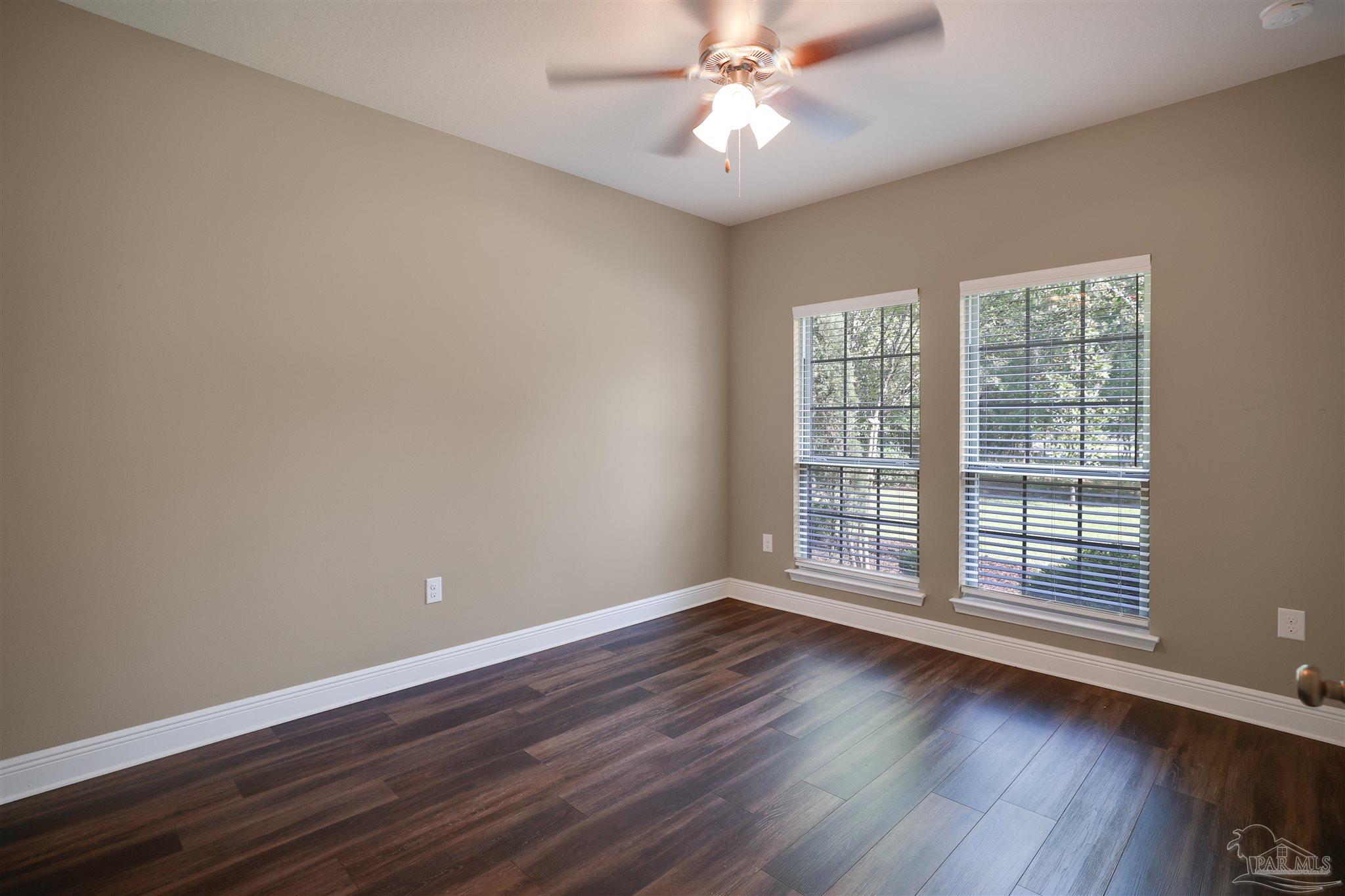 5847 Mossy Creek Lane Pace, FL 32571 - Photo 33 of 50 a view of an empty room with wooden floor and a window