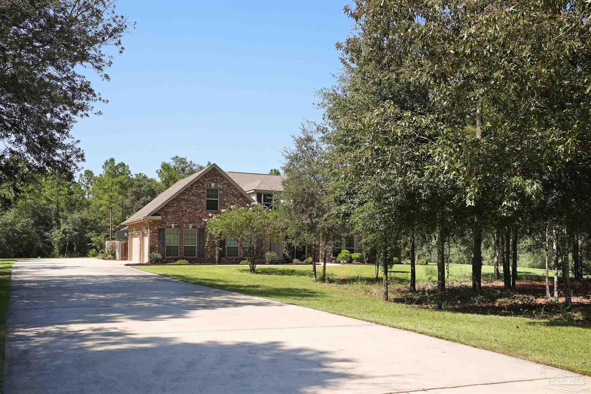 5847 Mossy Creek Lane Pace, FL 32571 - Photo 37 of 50 a view of a yard in front of a house