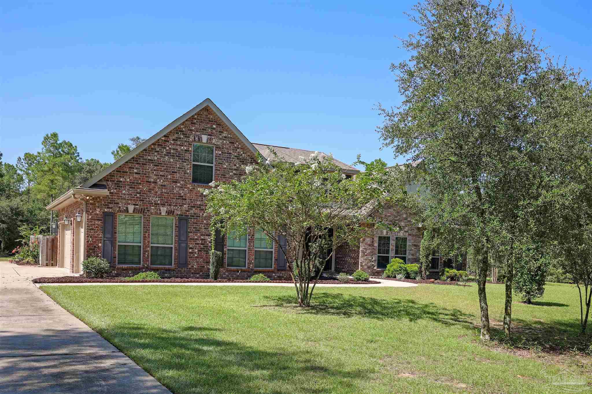 5847 Mossy Creek Lane Pace, FL 32571 - Photo 40 of 50 a front view of a house with garden