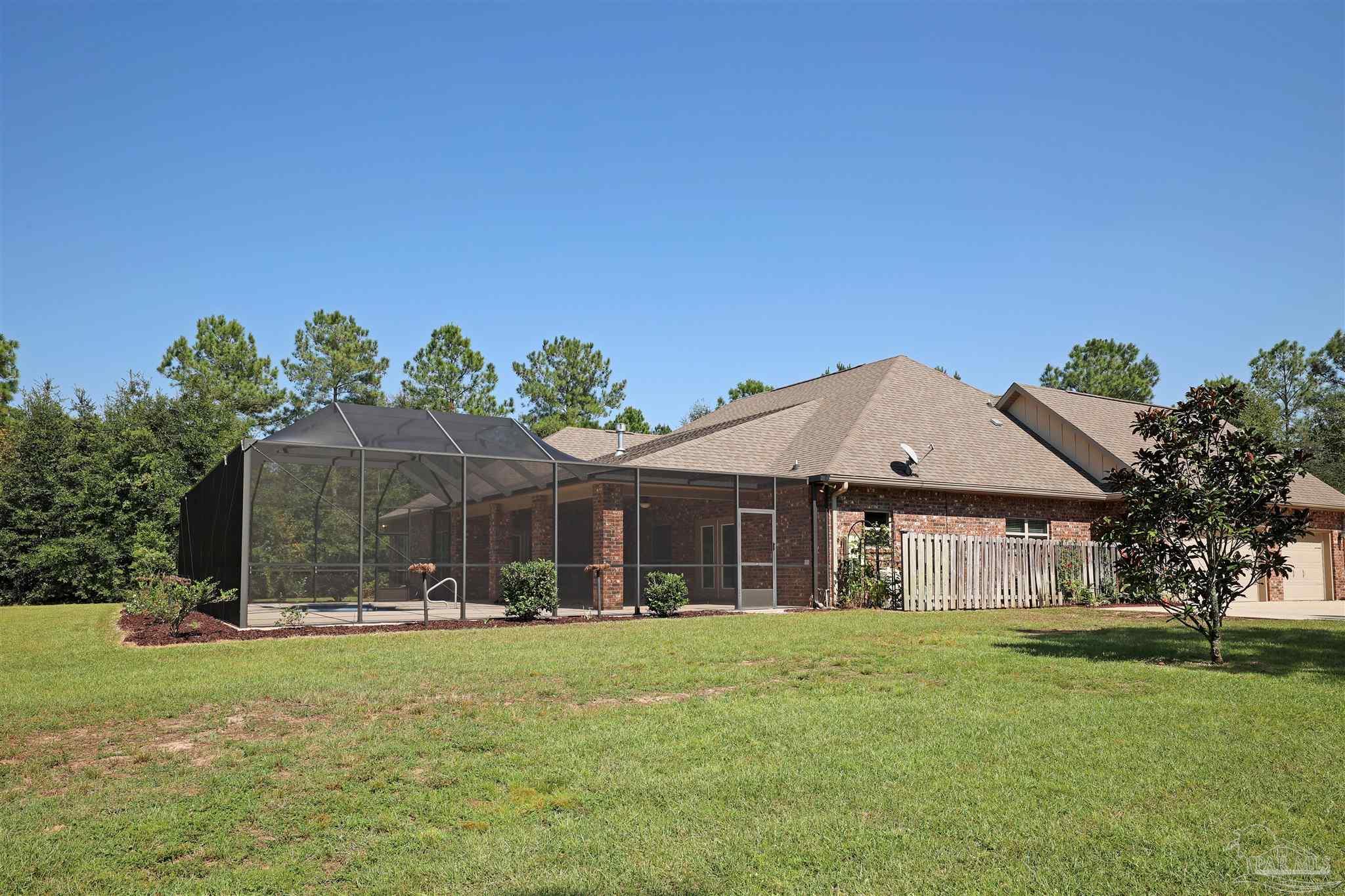 5847 Mossy Creek Lane Pace, FL 32571 - Photo 43 of 50 a front view of a house with a garden