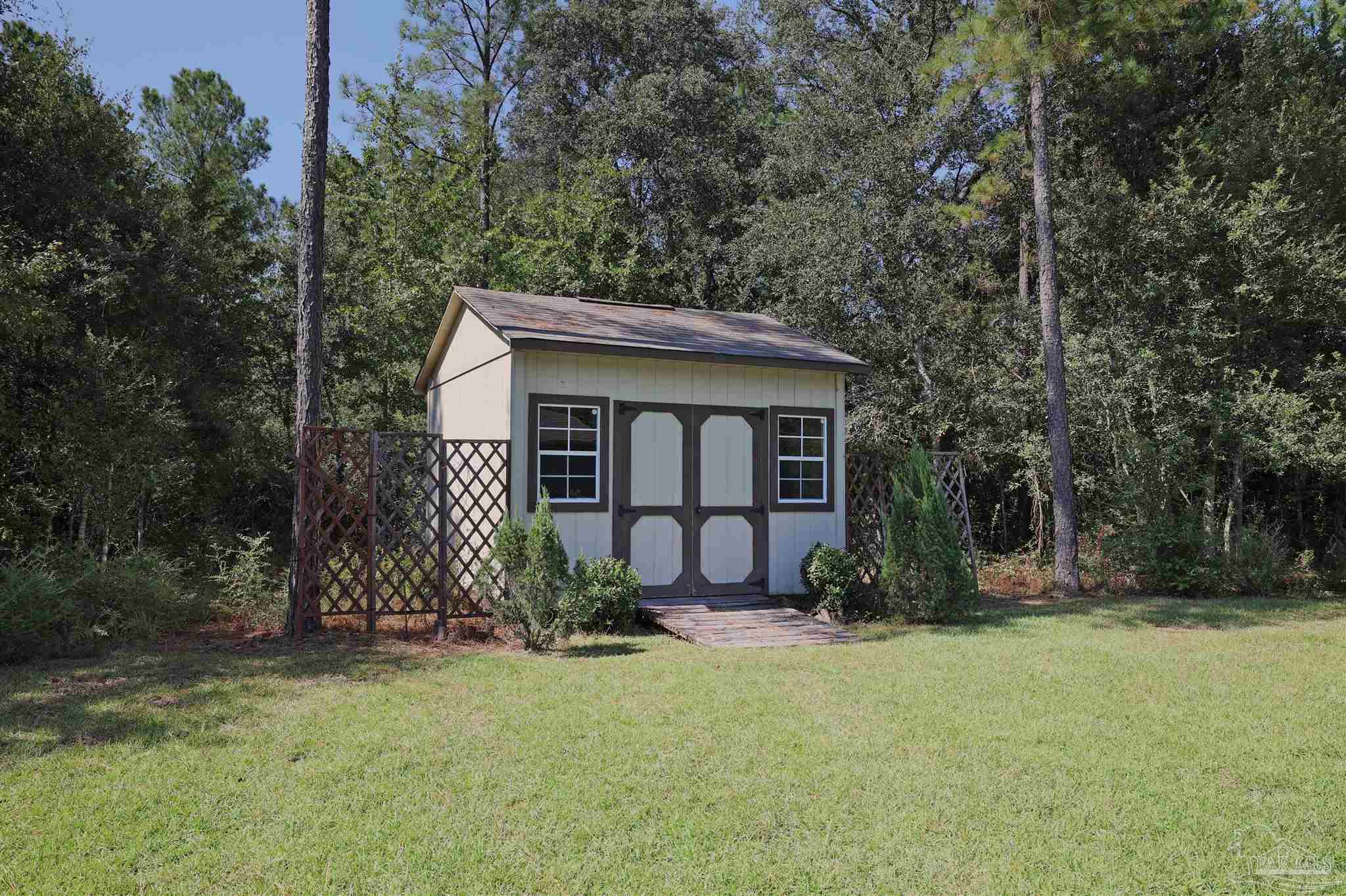 5847 Mossy Creek Lane Pace, FL 32571 - Photo 44 of 50 front view of a house with a yard
