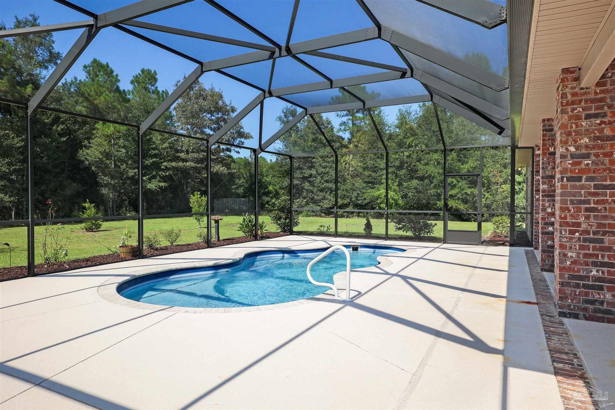 5847 Mossy Creek Lane Pace, FL 32571 - Photo 45 of 50 a view of a swimming pool with a patio