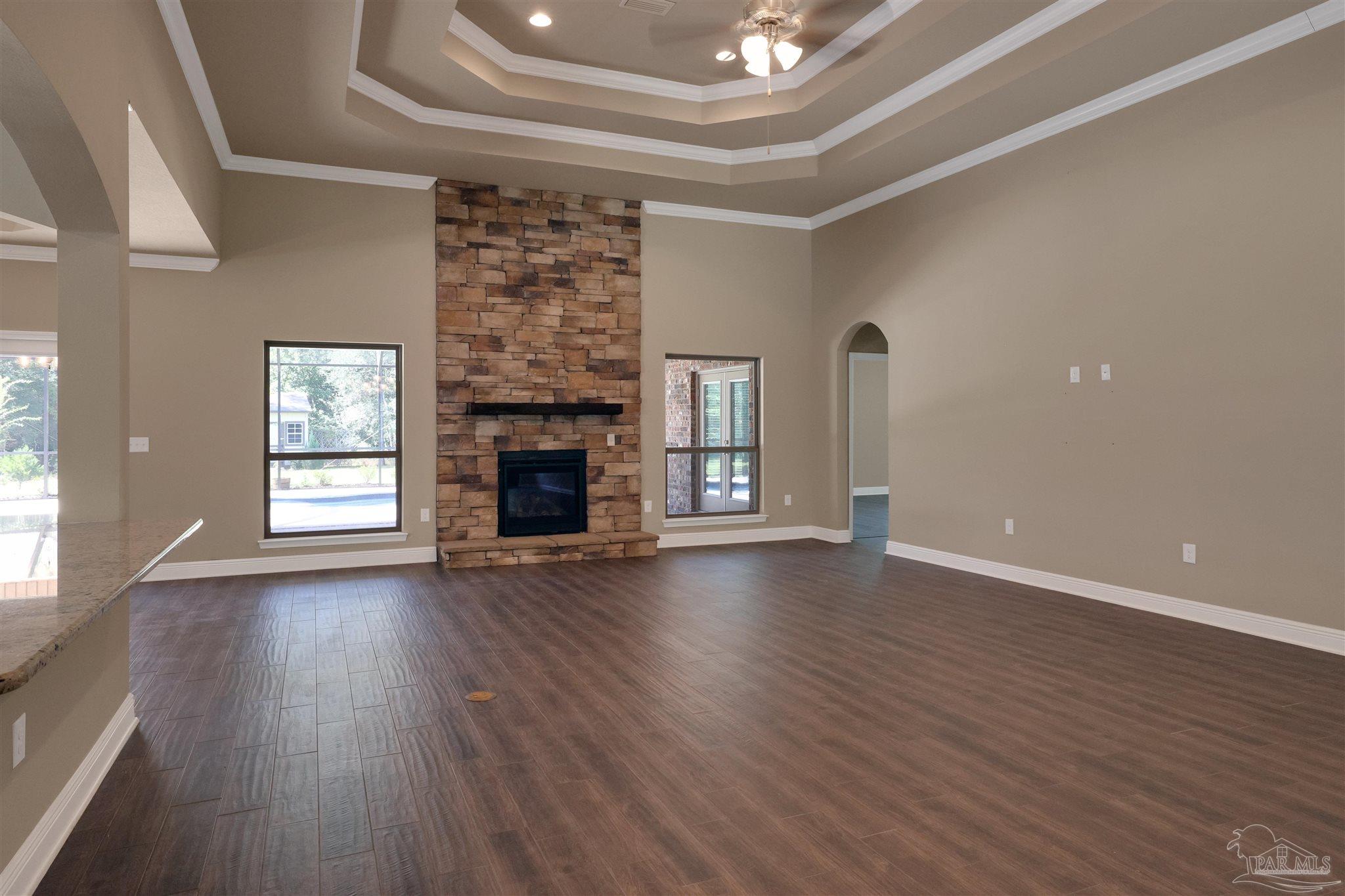 5847 Mossy Creek Lane Pace, FL 32571 - Photo 8 of 50 an empty room with wooden floor fireplace and windows