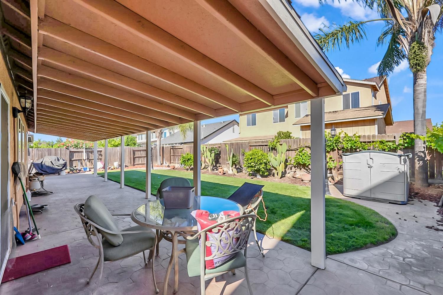 5432 Roselena Way Keyes, CA 95328 - Photo 15 of 16 a view of a patio with table and chairs under an umbrella
