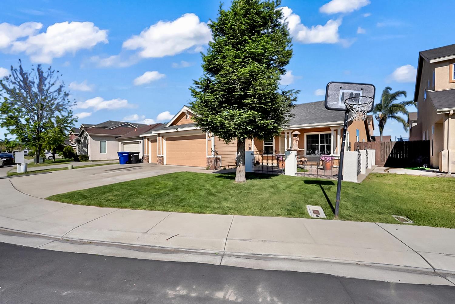 5432 Roselena Way Keyes, CA 95328 - Photo 4 of 16 a front view of a house with a yard and garage