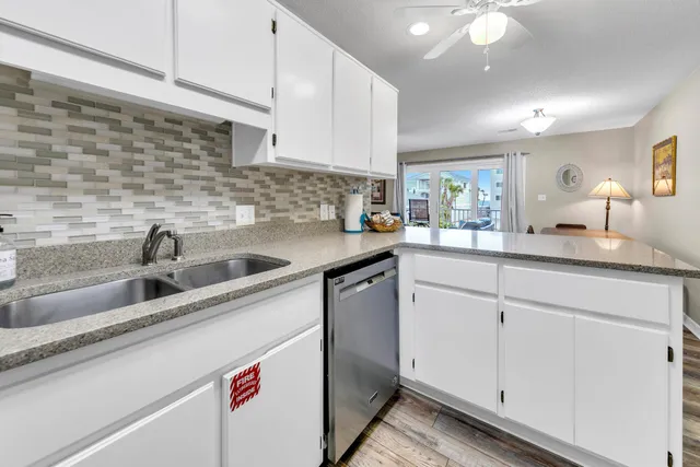 a kitchen with stainless steel appliances granite countertop a sink and cabinets