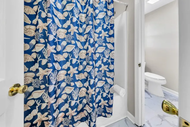 a bathroom with a bathtub and a shower curtain