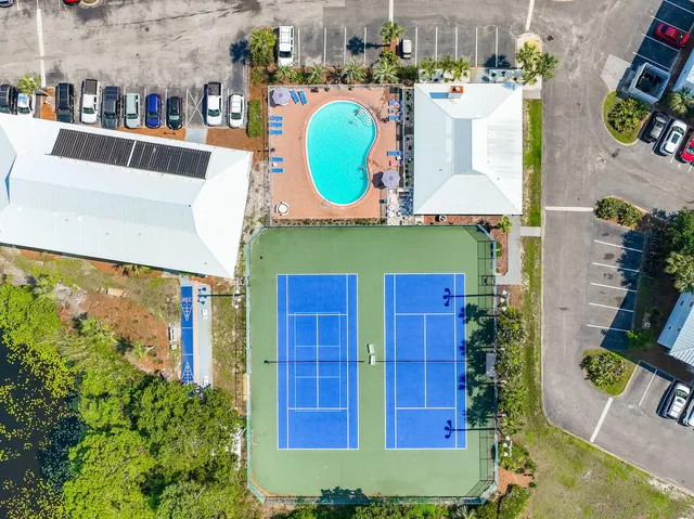 an aerial view of a house with outdoor space and seating area