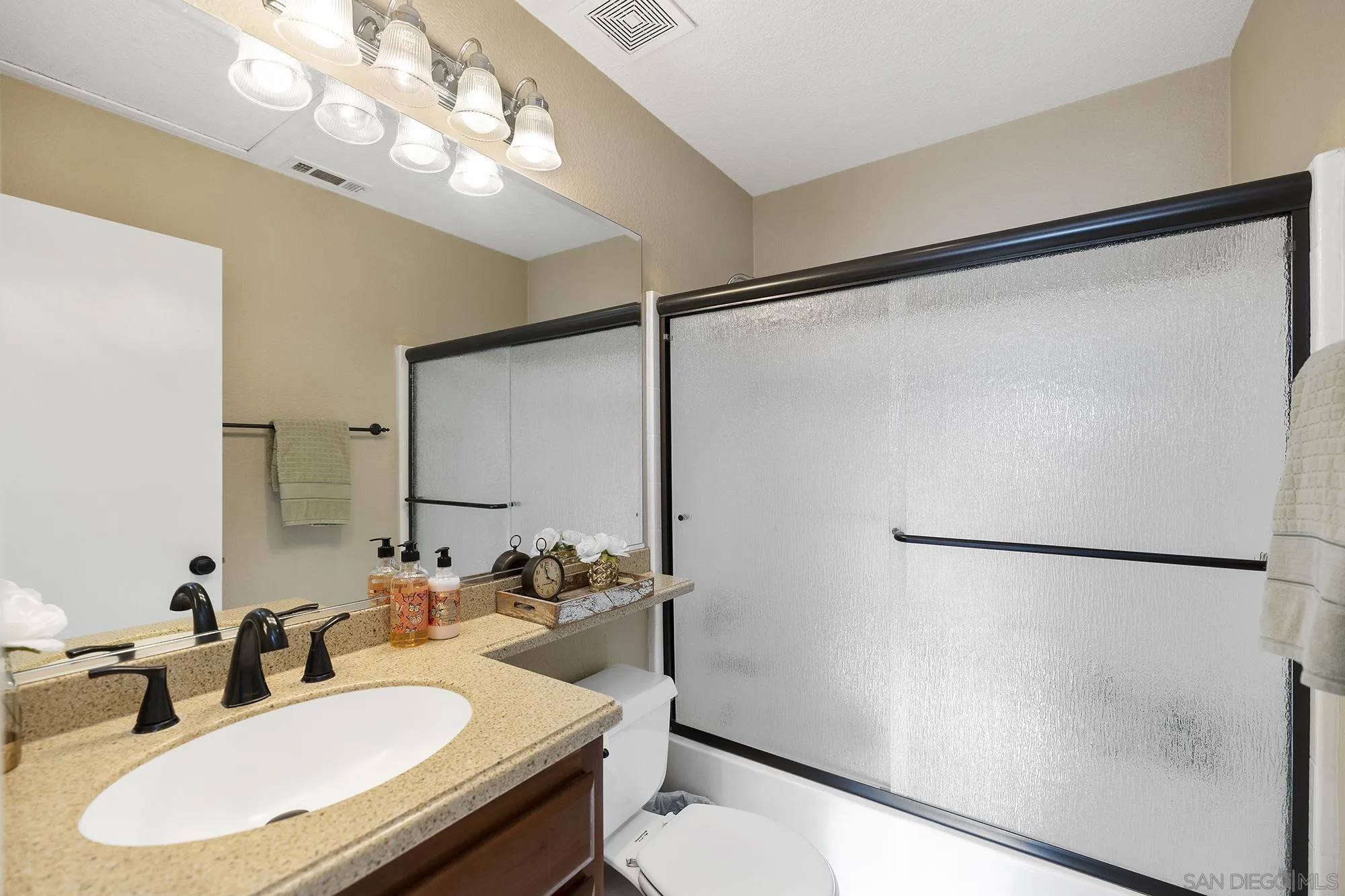 31450 Corte Rimola Temecula, CA 92592 - Photo 17 of 31 a bathroom with a sink vanity granite and a mirror