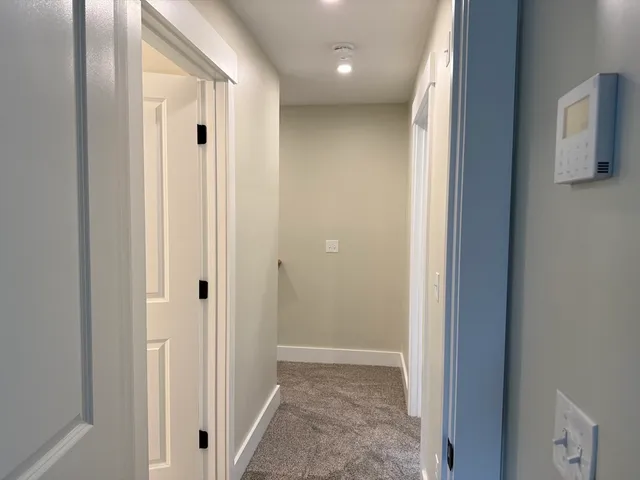 a view of hallway with closet and a window