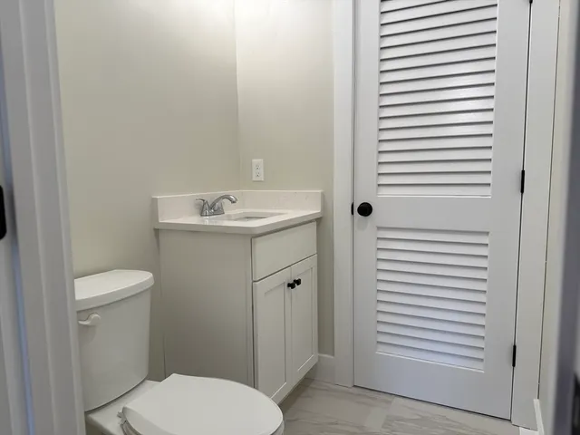 a bathroom with a toilet a sink and a window