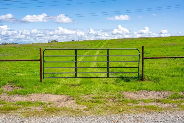 a view of a field with sitting area