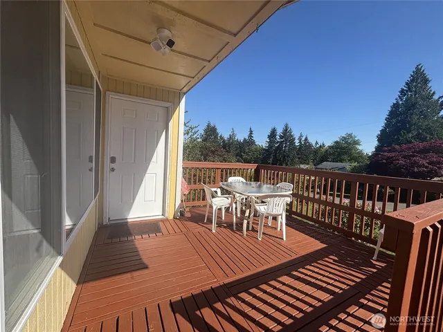 a view of a chairs and table on the roof deck