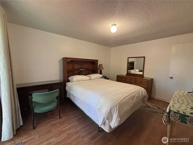a bedroom with a bed and a lamp