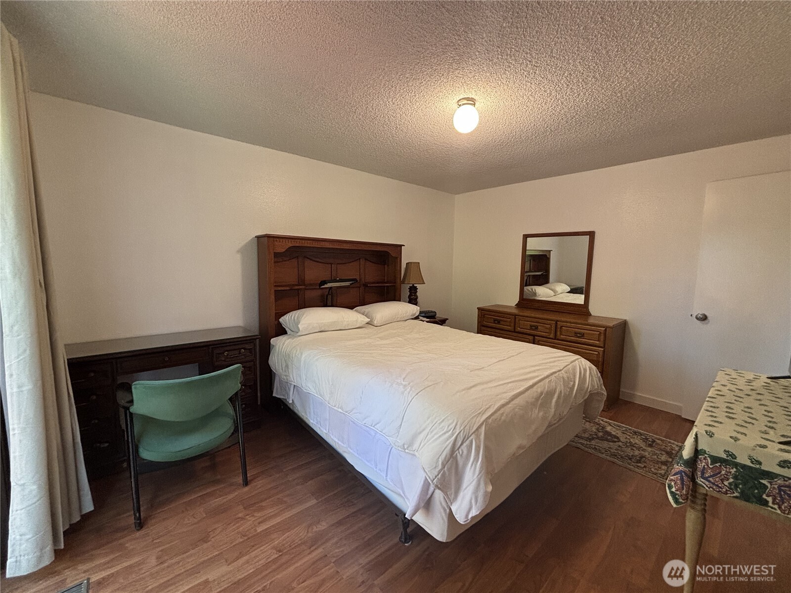 7265 East Harrison Street, Unit A Port Orchard, WA 98366 - Photo 13 of 17 a bedroom with a bed and a lamp