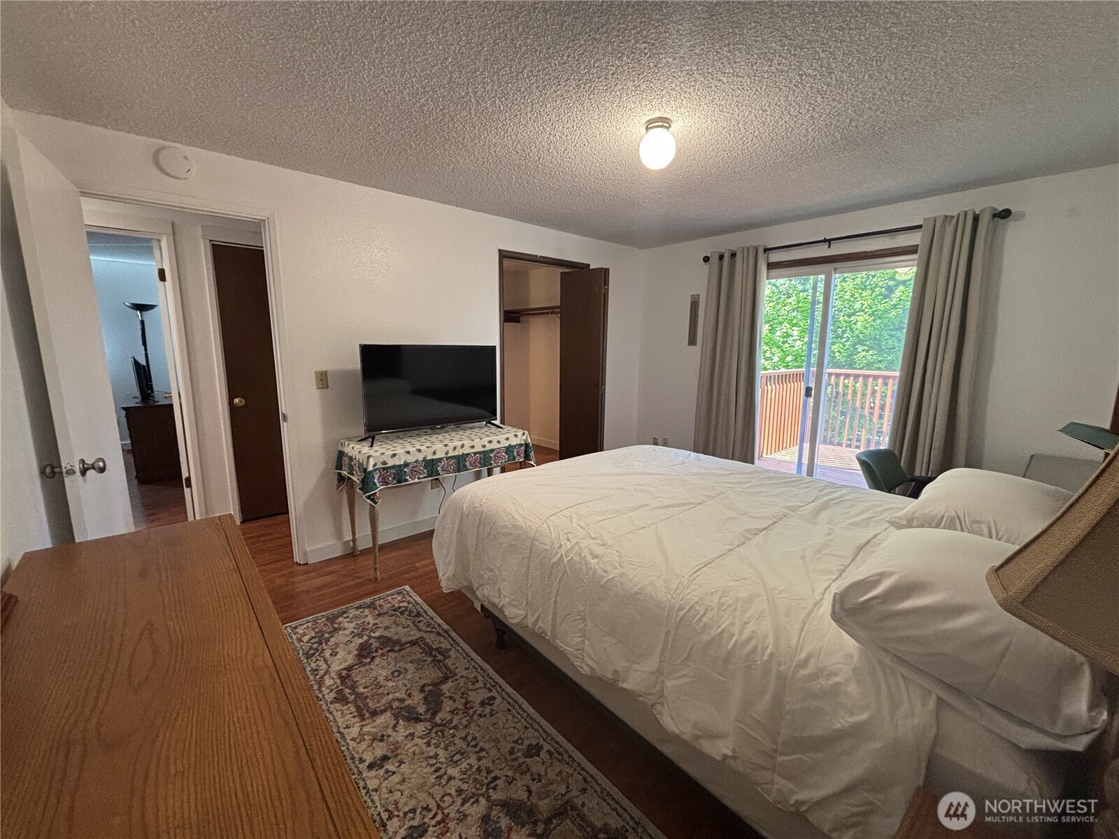 7265 East Harrison Street, Unit A Port Orchard, WA 98366 - Photo 14 of 17 a bedroom with a large bed and a flat screen tv