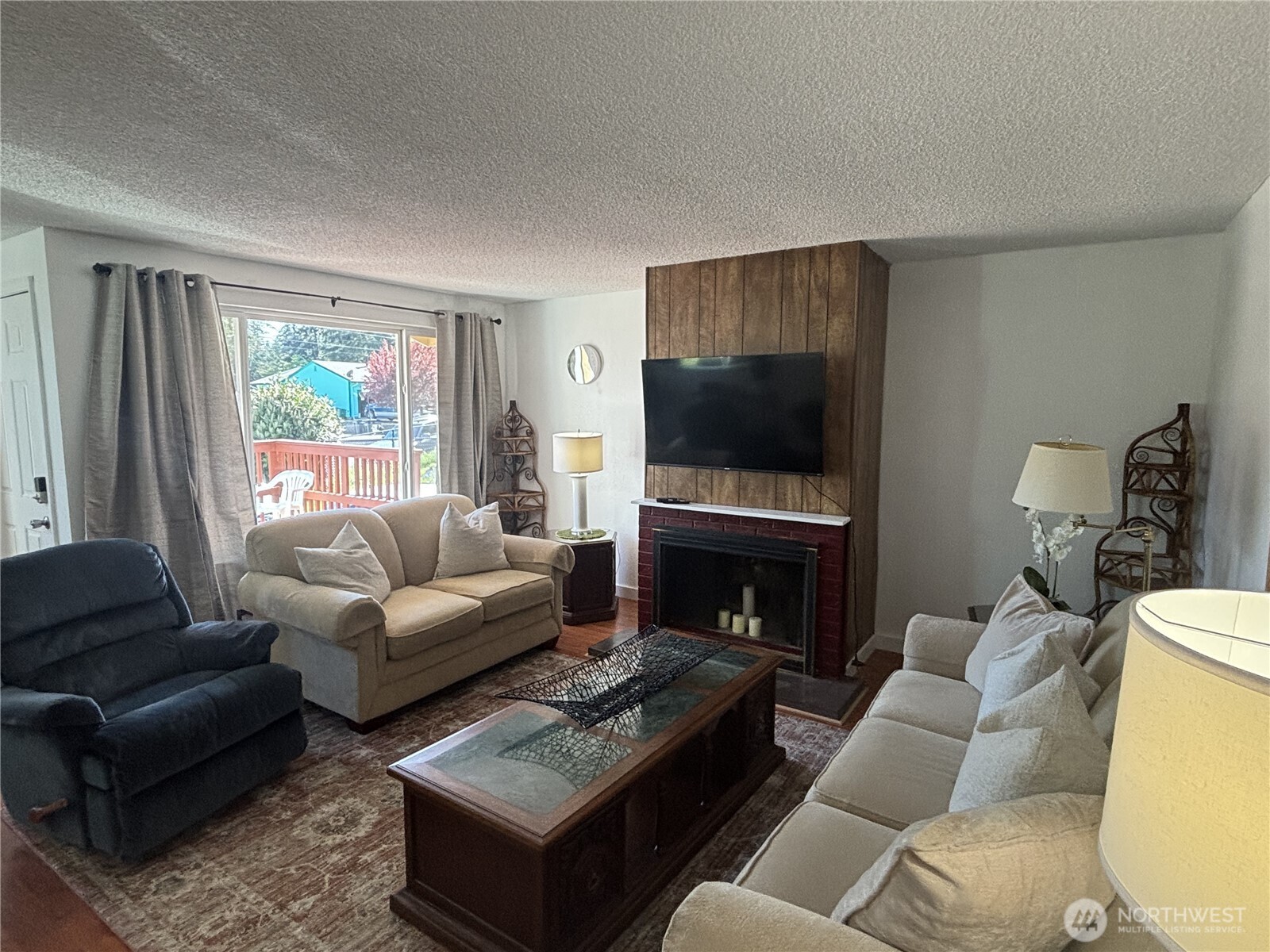 7265 East Harrison Street, Unit A Port Orchard, WA 98366 - Photo 8 of 17 a living room with furniture a flat screen tv and a fireplace