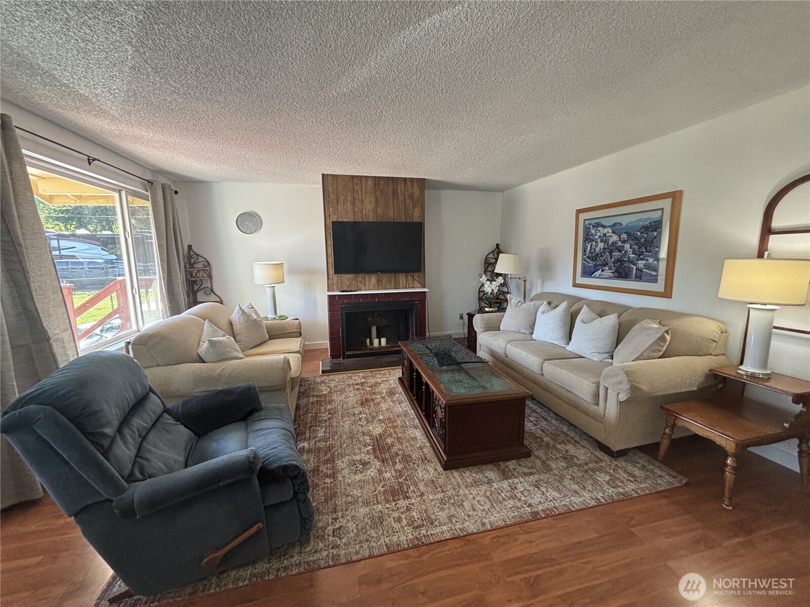 7265 East Harrison Street, Unit A Port Orchard, WA 98366 - Photo 9 of 17 a living room with furniture flat screen tv and a large window