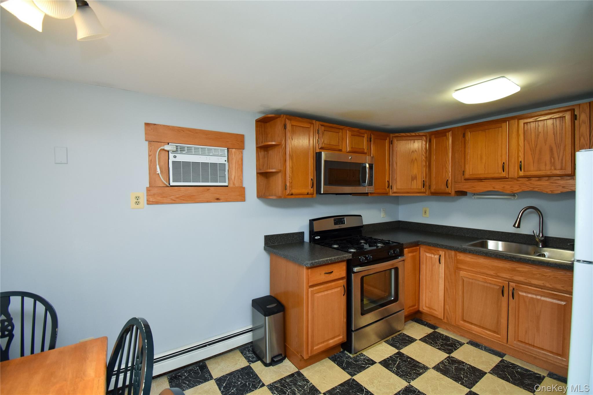 504 Highway 9D, Unit C Beacon, NY 12508 - Photo 3 of 9 a kitchen with stainless steel appliances a stove a sink a microwave a refrigerator and cabinets