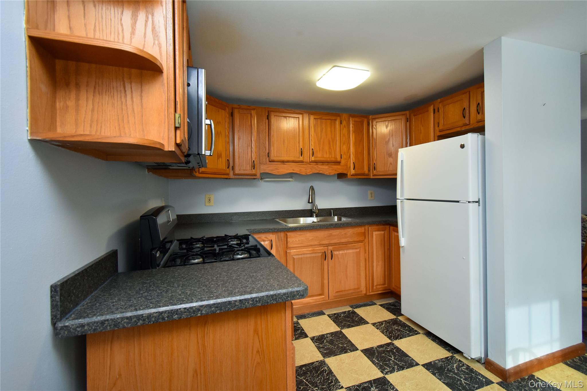 504 Highway 9D, Unit C Beacon, NY 12508 - Photo 4 of 9 a kitchen with a refrigerator and a sink