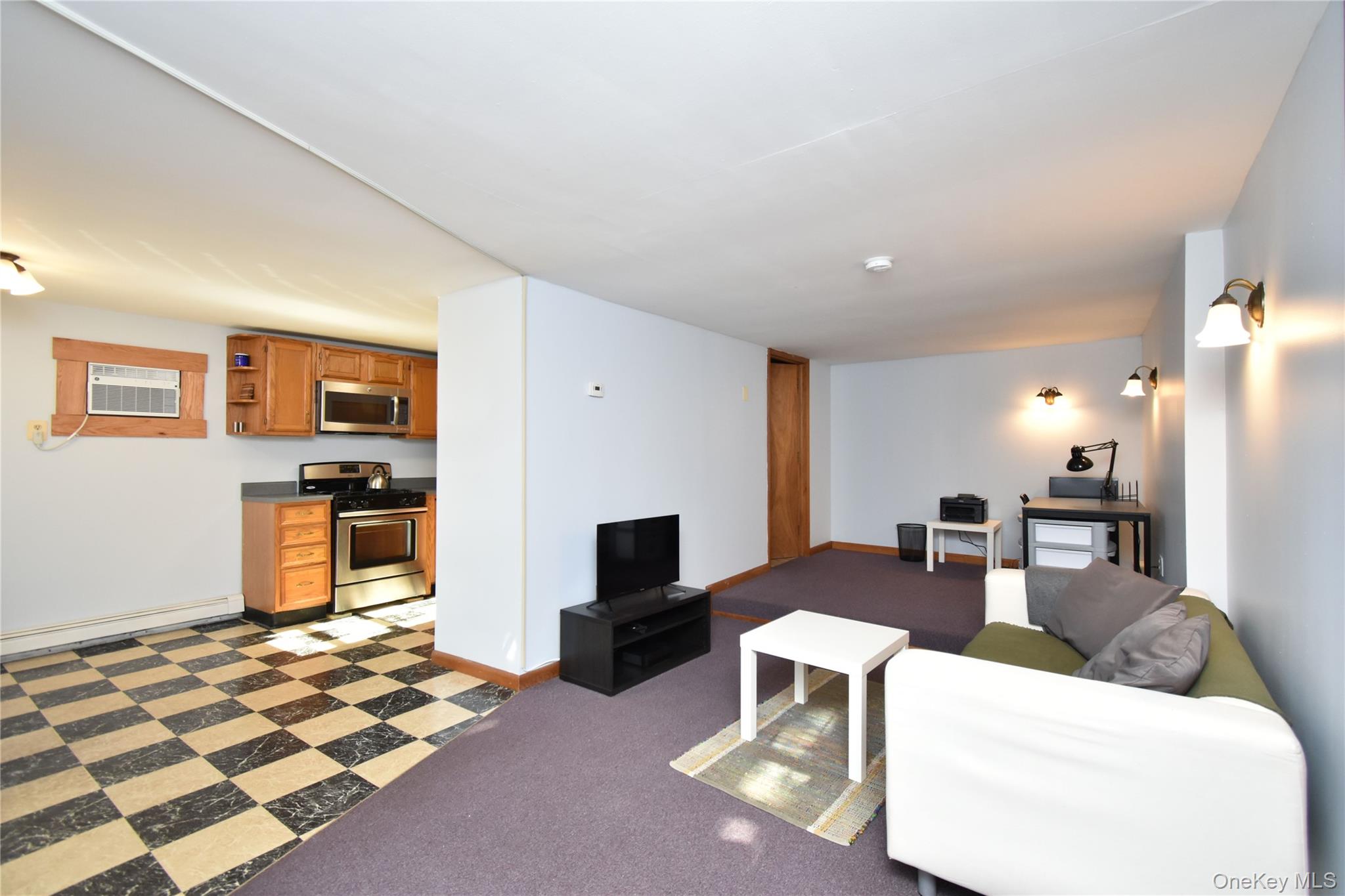 504 Highway 9D, Unit C Beacon, NY 12508 - Photo 5 of 9 a living room with furniture and a flat screen tv