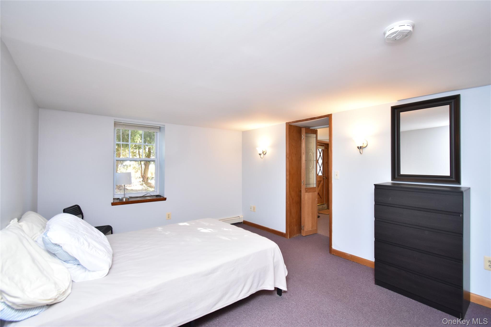 504 Highway 9D, Unit C Beacon, NY 12508 - Photo 6 of 9 a bedroom with a bed and a dresser