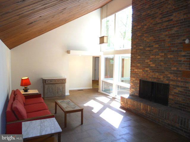 2659 Ogleton Road Annapolis, MD 21403 - Photo 4 of 22 Living room-vaulted wood ceiling, brick fireplace