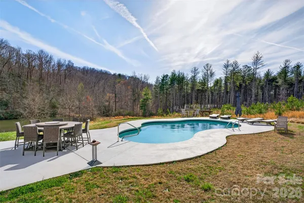 an outdoor space with swimming pool and furniture