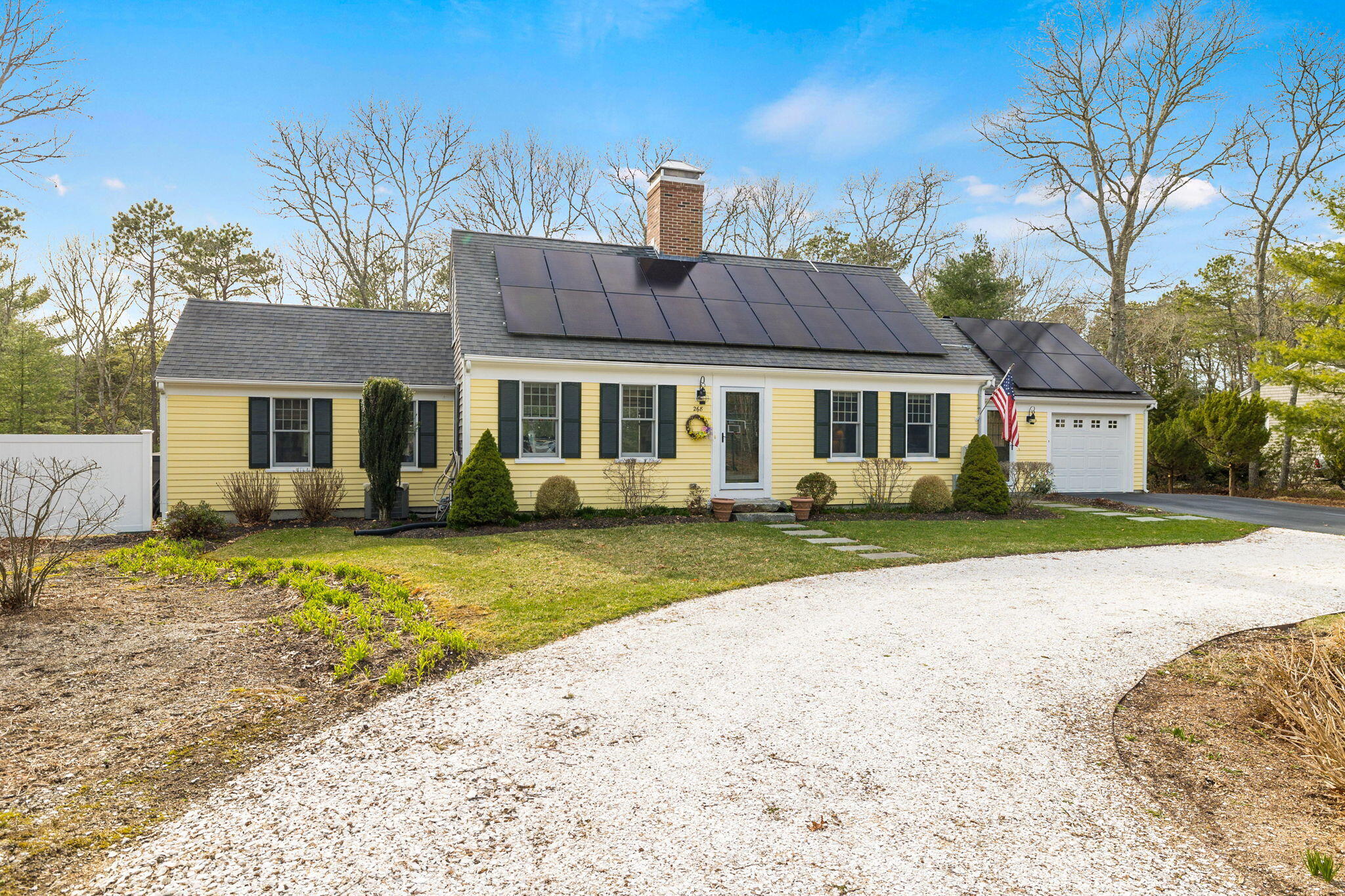268 Winding Cove Road Marstons Mills, MA 02648 - Photo 2 of 40 a front view of a house with a garden and trees