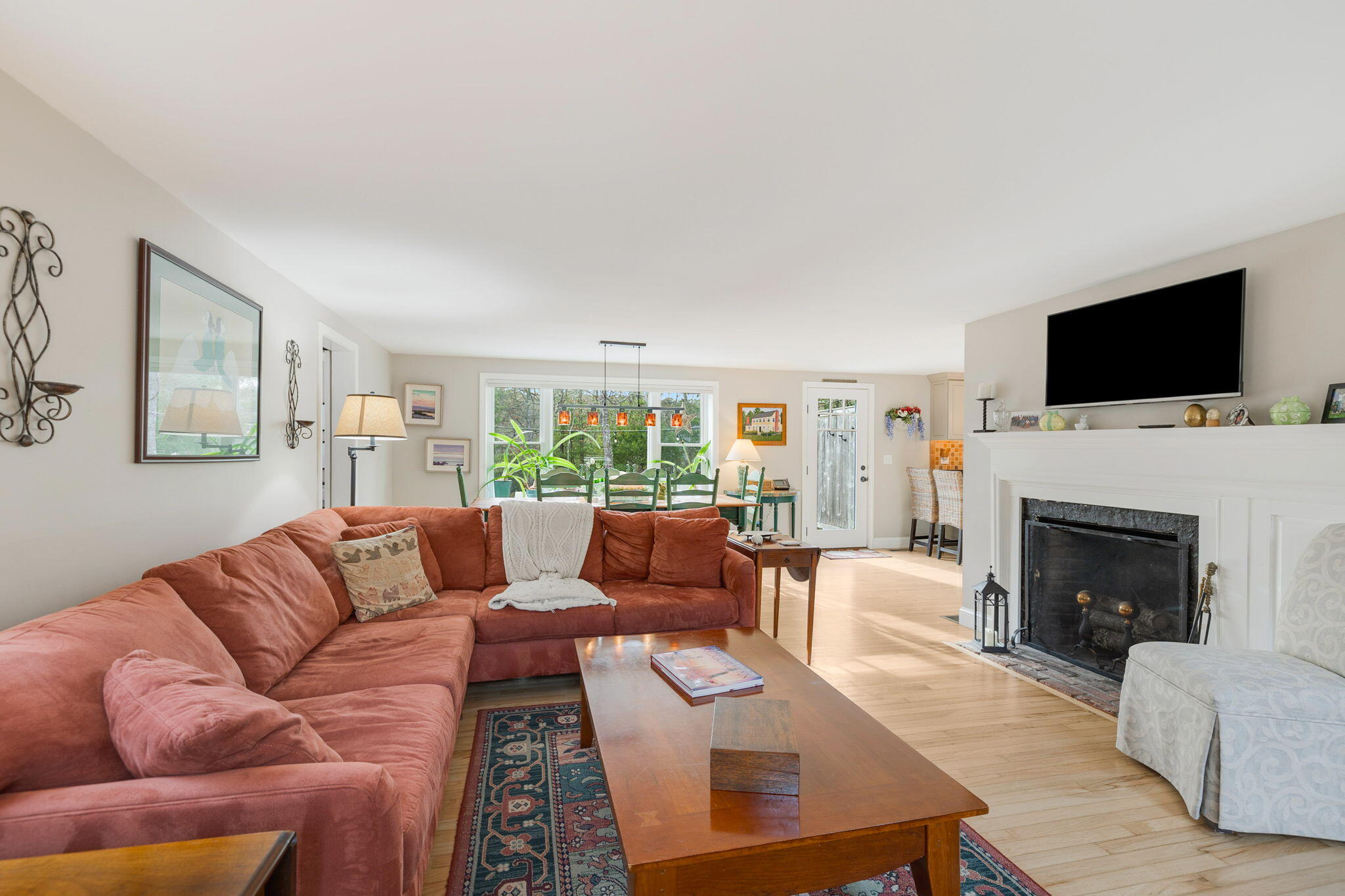 268 Winding Cove Road Marstons Mills, MA 02648 - Photo 3 of 40 a living room with furniture a flat screen tv and a fireplace