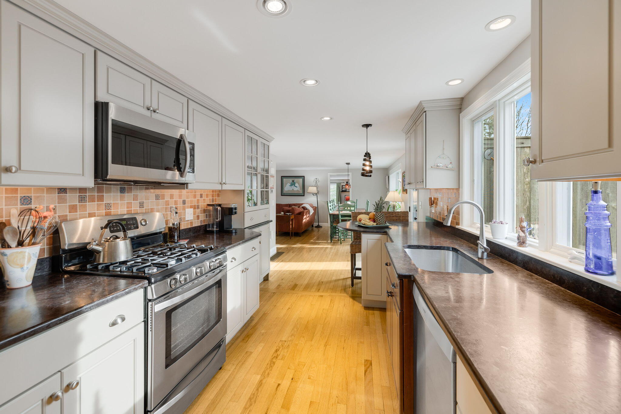 268 Winding Cove Road Marstons Mills, MA 02648 - Photo 8 of 40 a kitchen with stainless steel appliances granite countertop a sink a stove top oven a counter space and cabinets