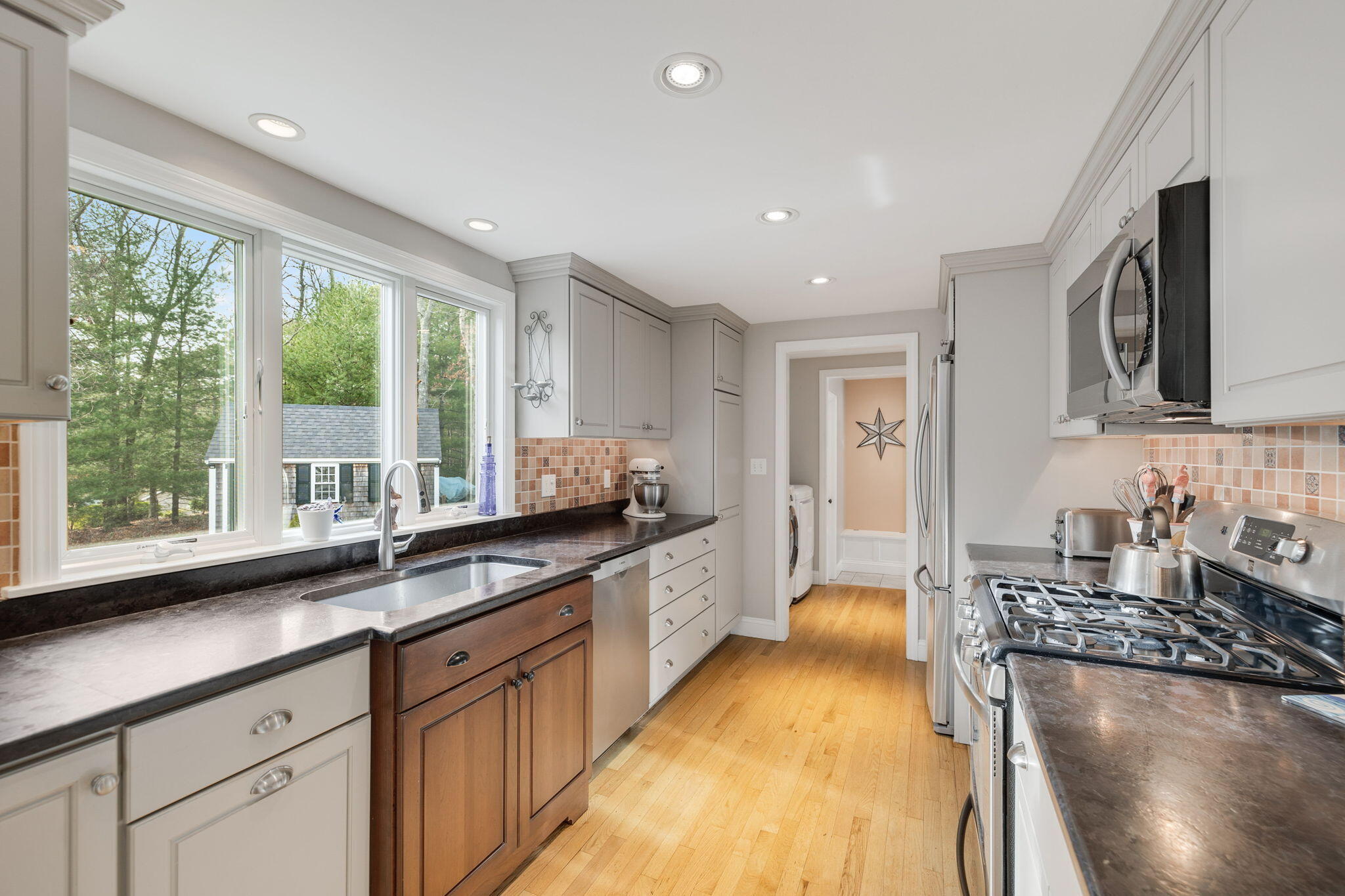 268 Winding Cove Road Marstons Mills, MA 02648 - Photo 9 of 40 a large kitchen with stainless steel appliances granite countertop a sink and a stove