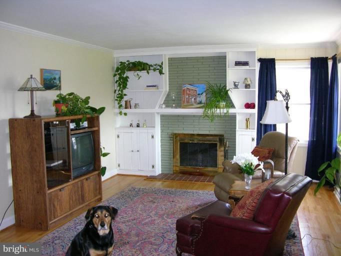 6710 Tweedbrook Road Baltimore, MD 21239 - Photo 2 of 6 a living room with furniture and a fireplace
