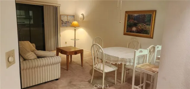 a living room with furniture a chandelier and a window