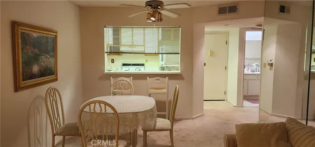 a workspace room with furniture and window