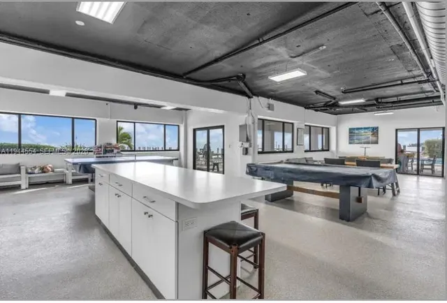 a large kitchen with lots of counter space a sink and appliances