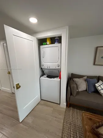 a living room with a couch and a stove with wooden floor
