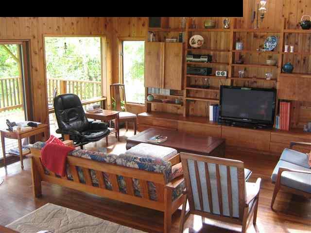 180 Ulaino Road Hana, HI 96713 - Photo 5 of 26 a living room with furniture a flat screen tv and large windows