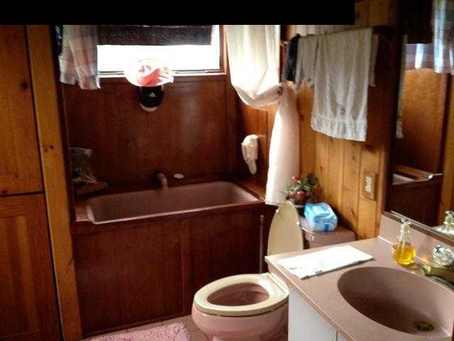 180 Ulaino Road Hana, HI 96713 - Photo 6 of 26 a bathroom with a sink mirror vanity and toilet