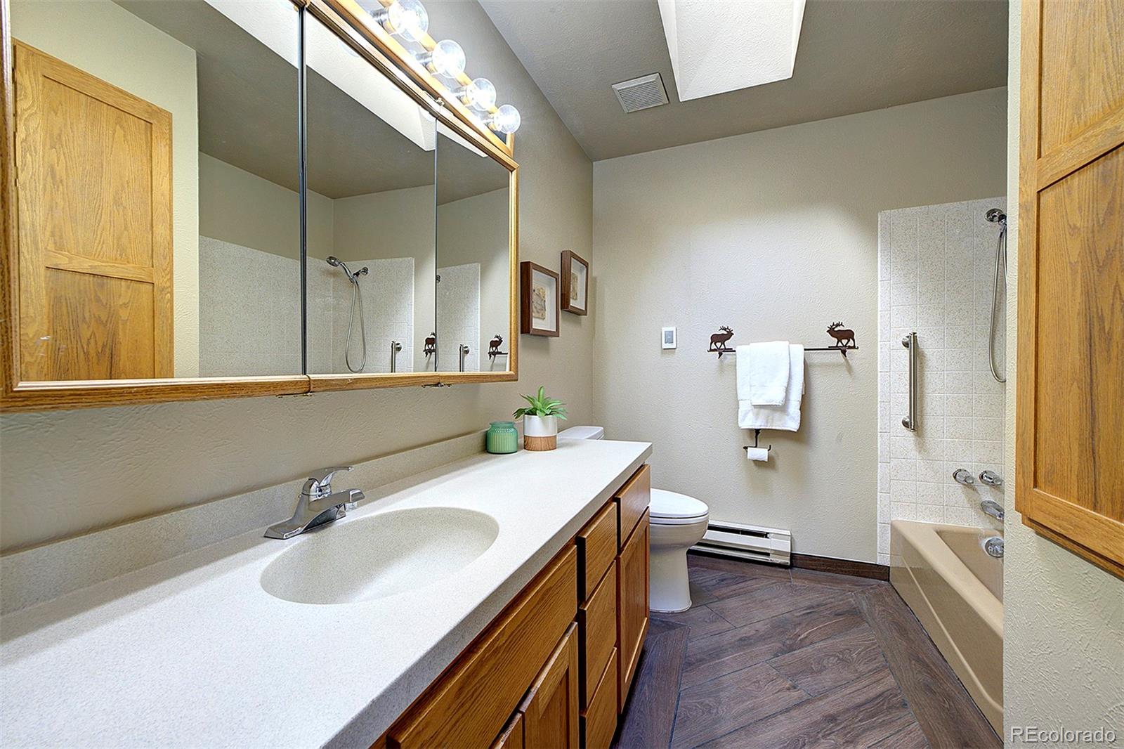 6561 Ridgeview Drive Morrison, CO 80465 - Photo 16 of 36 a bathroom with a sink and a mirror