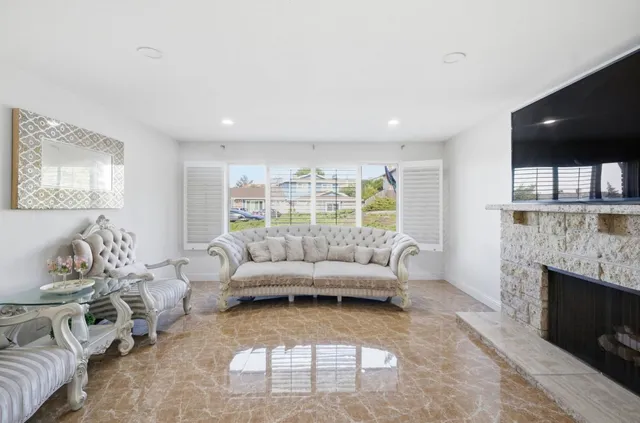 a view of a balcony with chairs and wooden floor