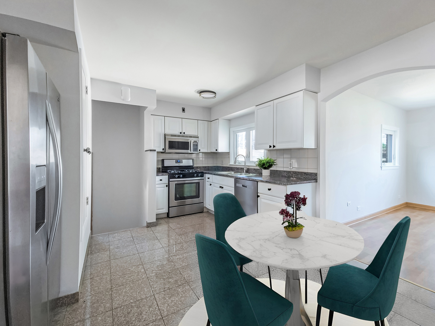 4313 Ruby Street Schiller Park, IL 60176 - Photo 5 of 25 a kitchen with stainless steel appliances granite countertop a sink a stove a dining table and chairs