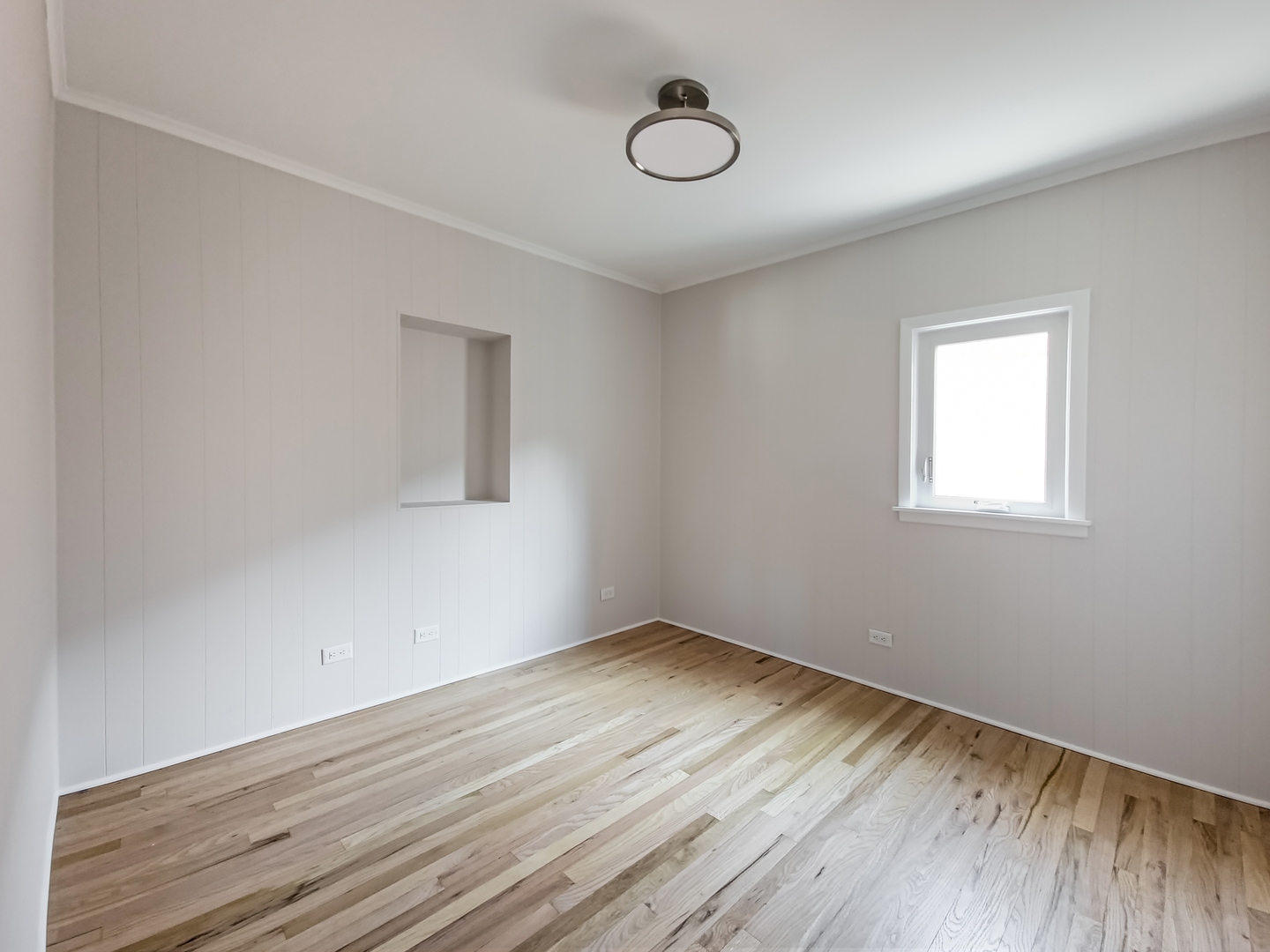4313 Ruby Street Schiller Park, IL 60176 - Photo 8 of 25 a view of an empty room with wooden floor and a window