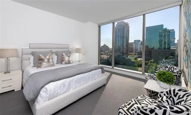 a spacious bedroom with a bed and a large window