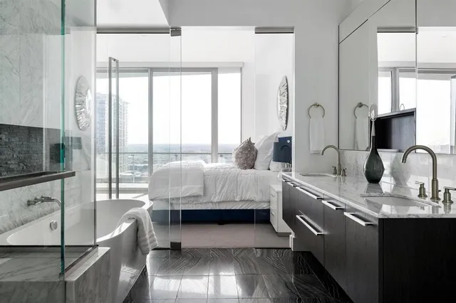 a bedroom with a bed and a large window