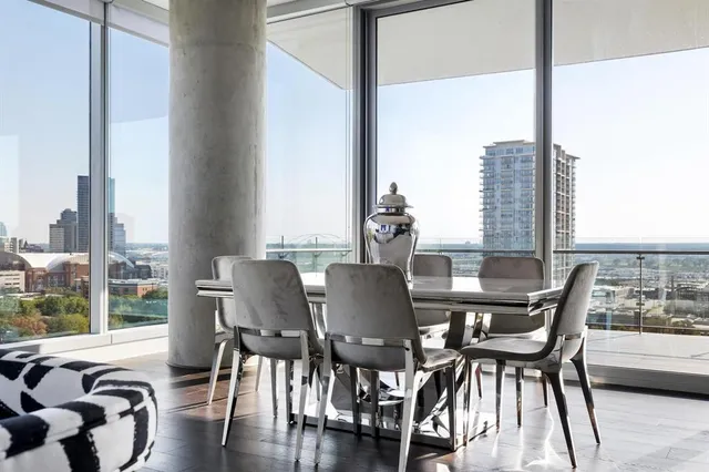 a bedroom with two beds next to a large window