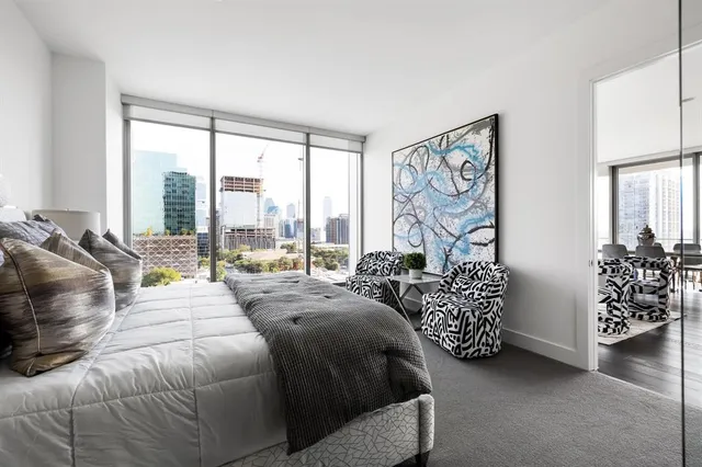 a bedroom with a bed and a large window